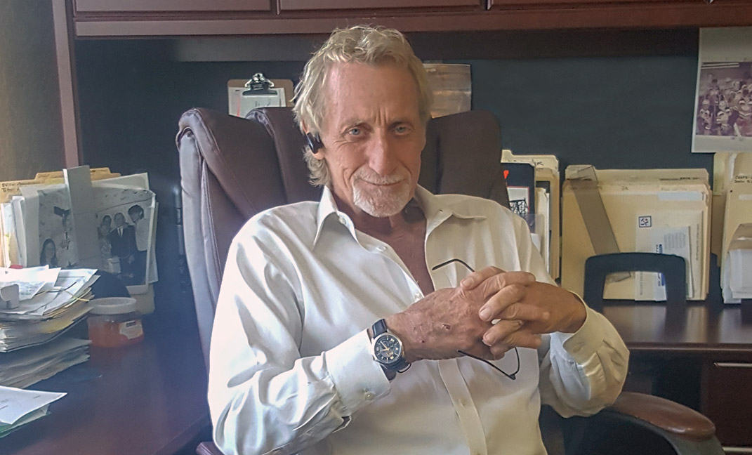 R. D. Jones sitting at his desk.