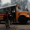 children getting on school bus