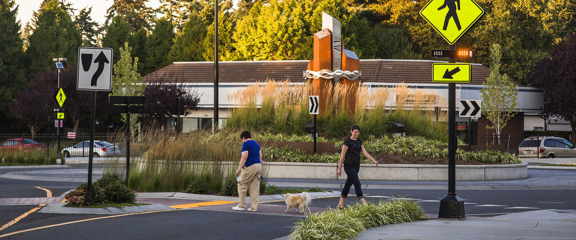 Woman crossing the roundabout using a solar RRFB system in Edmonds, Washington