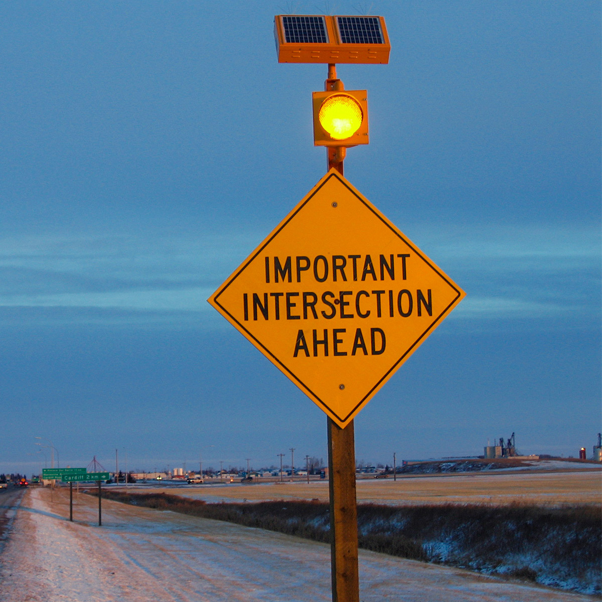 solar-powered warning sign beacon on important intersection ahead sign