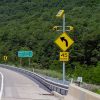 solar-powered warning sign flashing beacon on highway sign