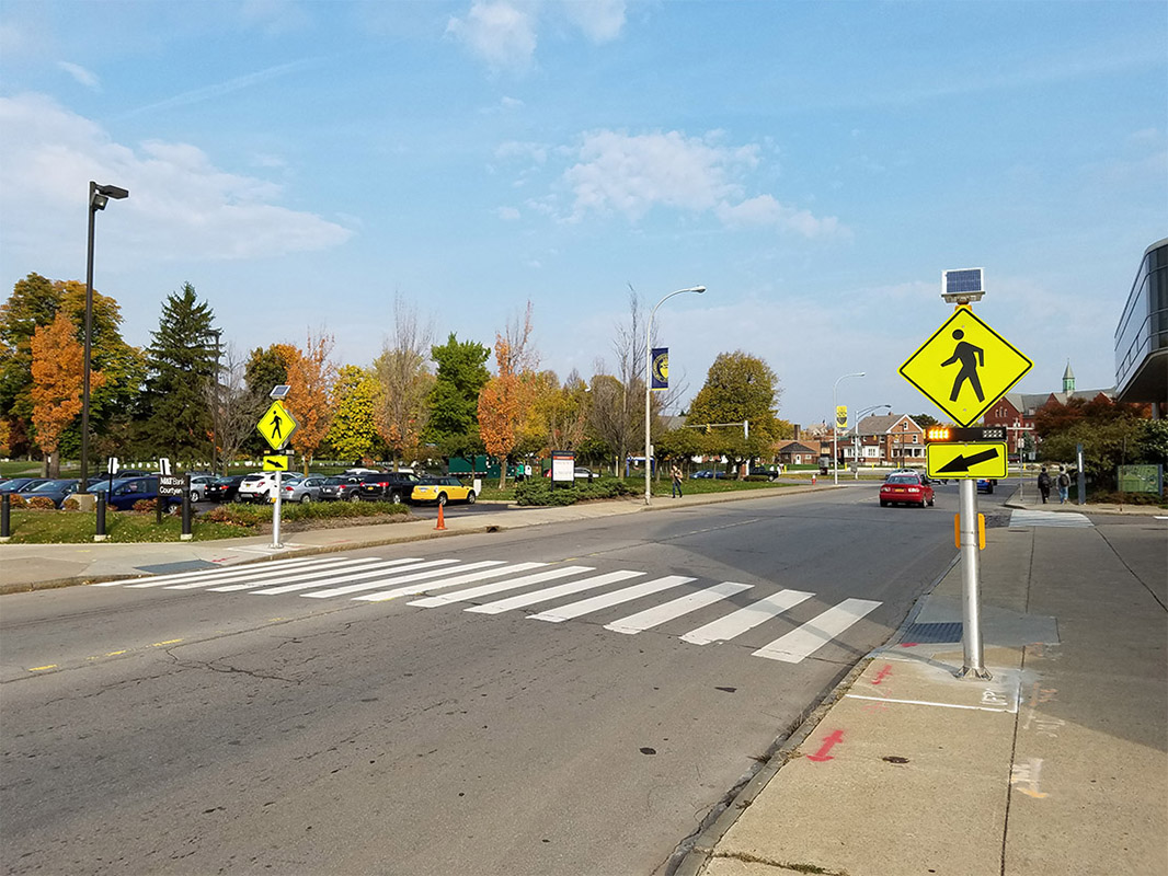 Midblock crosswalk in Buffalo, New York equipped with solar-powered rectangular rapid flashing beacons