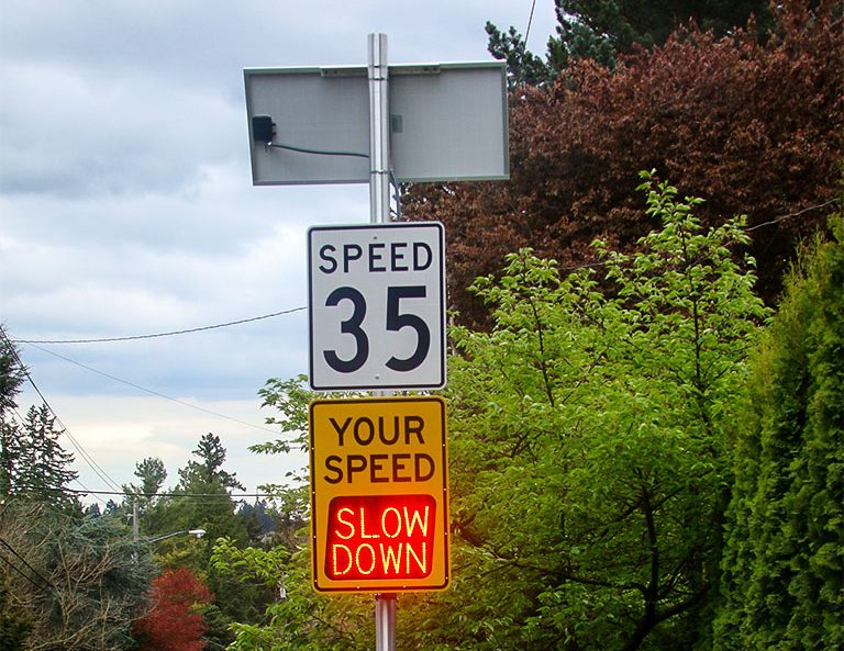 speedcheck speed radar sign flashing slow down message in cedar mills, oregon