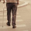 man with cane crossing street